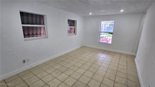 10 E Jersey Rd, Lehigh Acres, FL 33936 - unfurnished room featuring light tile patterned floors, recessed lighting, baseboards, and a textured ceiling