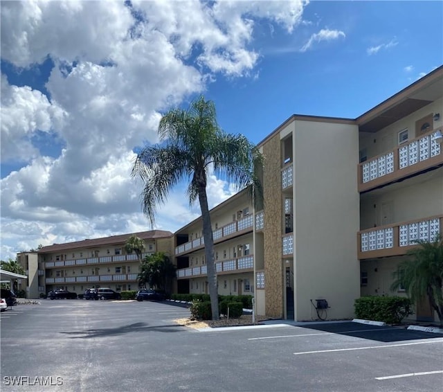 1515 Tropic Ter Unit 1515, North Fort Myers, FL 33903 - view of apartment building / complex featuring uncovered parking