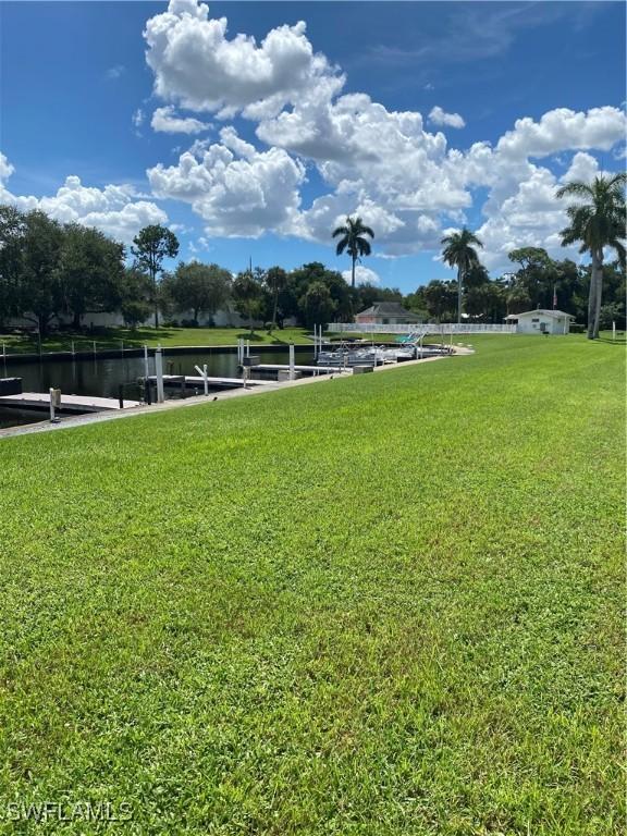 1515 Tropic Ter Unit 1515, North Fort Myers, FL 33903 - view of grassy yard featuring a boat dock and a water view