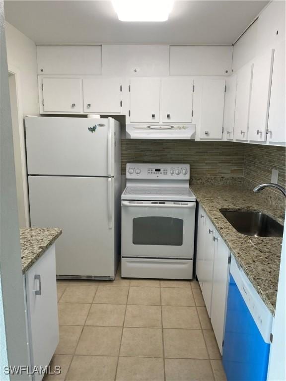 1515 Tropic Ter Unit 1515, North Fort Myers, FL 33903 - kitchen featuring white appliances, a sink, under cabinet range hood, light tile patterned flooring, and white cabinetry