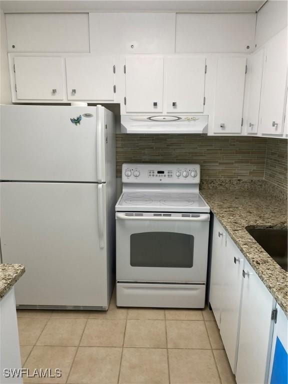 1515 Tropic Ter Unit 1515, North Fort Myers, FL 33903 - kitchen featuring white appliances, under cabinet range hood, white cabinets, and light tile patterned floors