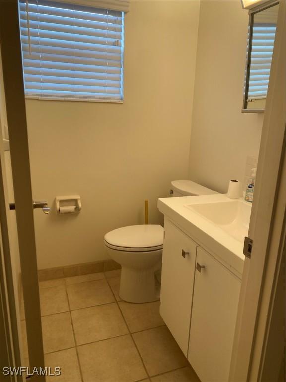 1515 Tropic Ter Unit 1515, North Fort Myers, FL 33903 - half bath featuring vanity, toilet, tile patterned floors, and plenty of natural light