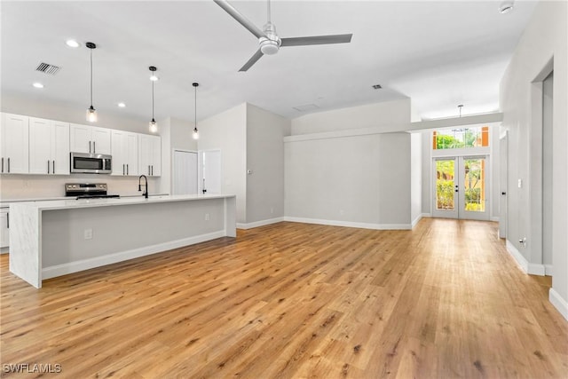 3519 Heron Cove Ct, Bonita Springs, FL 34134 - unfurnished living room featuring a sink, light wood-style flooring, ceiling fan, recessed lighting, and baseboards