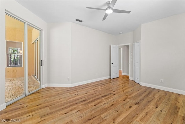 3519 Heron Cove Ct, Bonita Springs, FL 34134 - unfurnished bedroom with light wood-style flooring, baseboards, and a ceiling fan