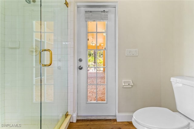 3519 Heron Cove Ct, Bonita Springs, FL 34134 - full bathroom featuring toilet, a stall shower, wood finished floors, and baseboards