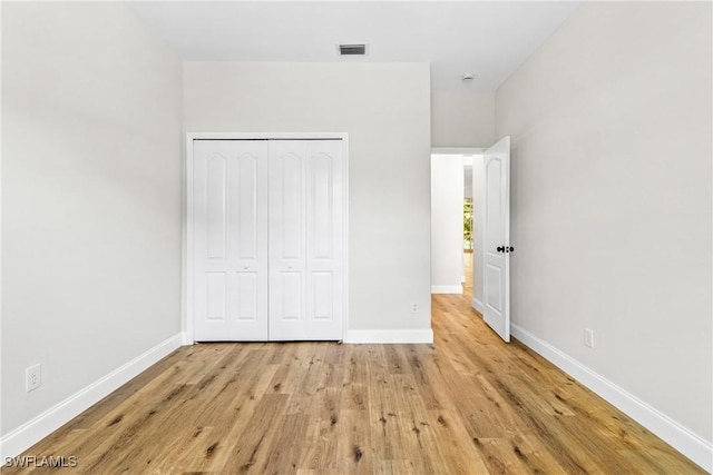 3519 Heron Cove Ct, Bonita Springs, FL 34134 - unfurnished bedroom featuring light wood-type flooring, baseboards, and a closet