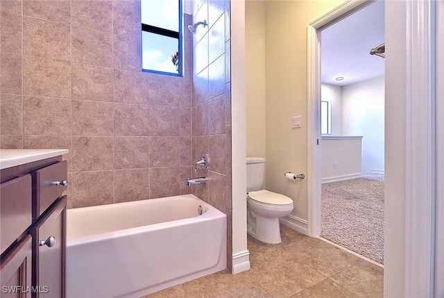 9440 Sardinia Way Unit 110, Fort Myers, FL 33908 - bathroom featuring toilet, vanity, tile patterned flooring, bathtub / shower combination, and baseboards