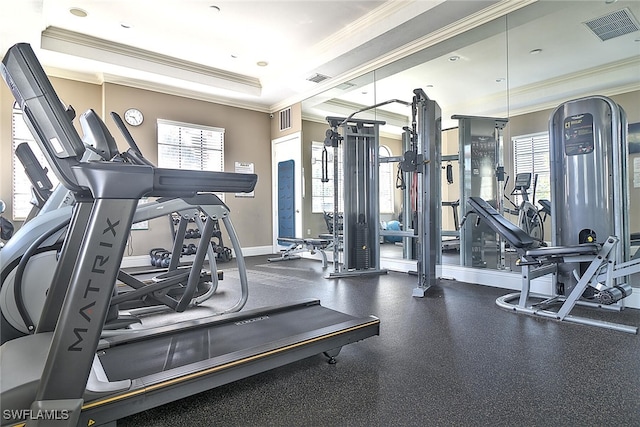9440 Sardinia Way Unit 110, Fort Myers, FL 33908 - exercise room featuring crown molding, healthy amount of natural light, a raised ceiling, and baseboards