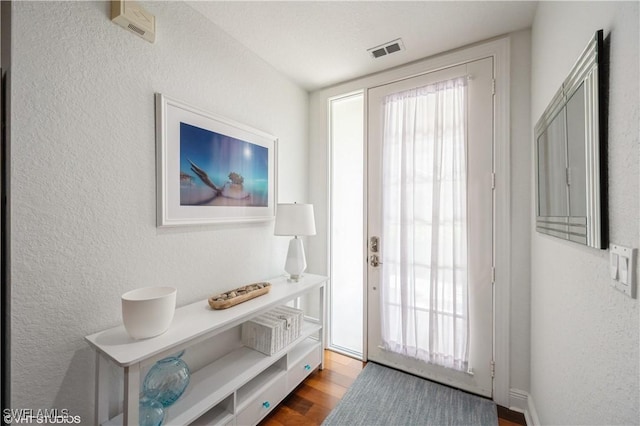 4610 Hawks Nest Dr Unit A104, Naples, FL 34114 - entryway featuring a textured wall and wood finished floors