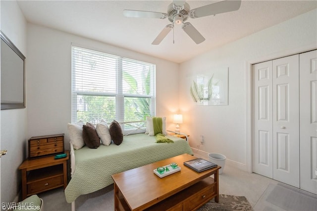 4610 Hawks Nest Dr Unit A104, Naples, FL 34114 - bedroom with light carpet, a closet, ceiling fan, and baseboards