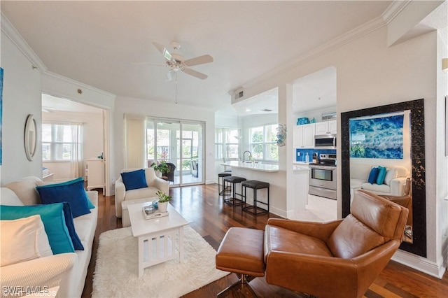 4610 Hawks Nest Dr Unit A104, Naples, FL 34114 - living room featuring ceiling fan, wood finished floors, healthy amount of natural light, crown molding, and baseboards