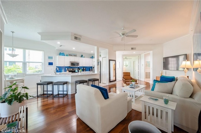 4610 Hawks Nest Dr Unit A104, Naples, FL 34114 - living area with a ceiling fan, dark wood-style flooring, ornamental molding, and recessed lighting