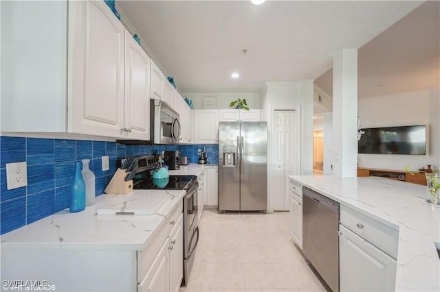 4610 Hawks Nest Dr Unit A104, Naples, FL 34114 - kitchen featuring stainless steel appliances, light stone counters, white cabinetry, decorative backsplash, and recessed lighting