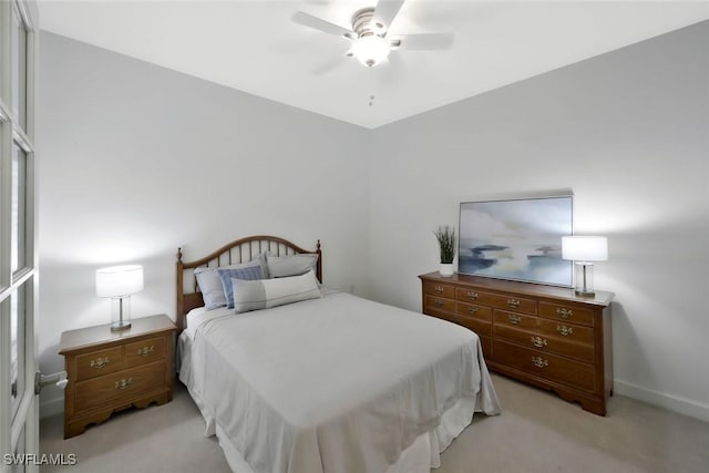 8565 Via Garibaldi Cir Unit 104, Estero, FL 33928 - bedroom featuring light carpet, a ceiling fan, and baseboards