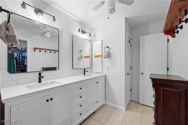 663 110th Ave N, Naples, FL 34108 - bathroom featuring a ceiling fan, double vanity, tile patterned floors, and a walk in closet
