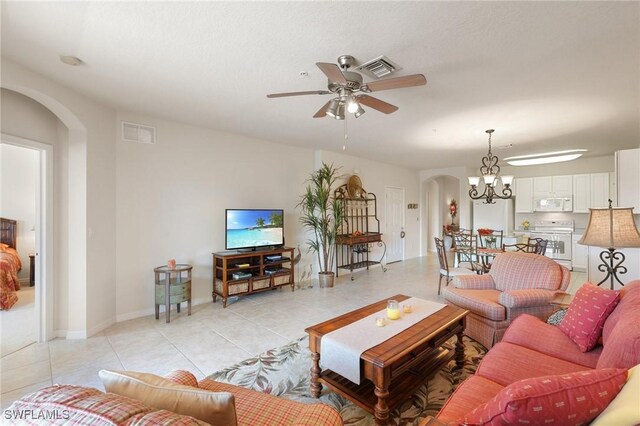 9631 Spanish Moss Way Unit 3923, Bonita Springs, FL 34135 - living room featuring arched walkways, ceiling fan, light tile patterned flooring, a chandelier, and baseboards