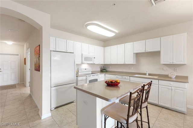 9631 Spanish Moss Way Unit 3923, Bonita Springs, FL 34135 - kitchen featuring white appliances, a sink, light tile patterned floors, and a kitchen bar