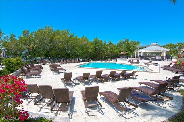 430 Cove Tower Dr Unit 501, Naples, FL 34110 - community pool featuring a gazebo and a patio area