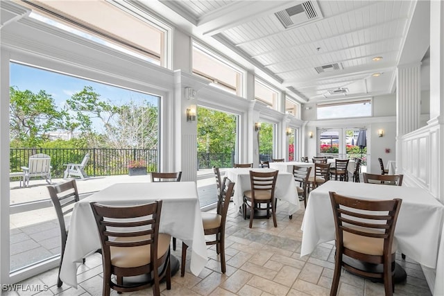 430 Cove Tower Dr Unit 501, Naples, FL 34110 - dining area featuring a towering ceiling and stone tile flooring