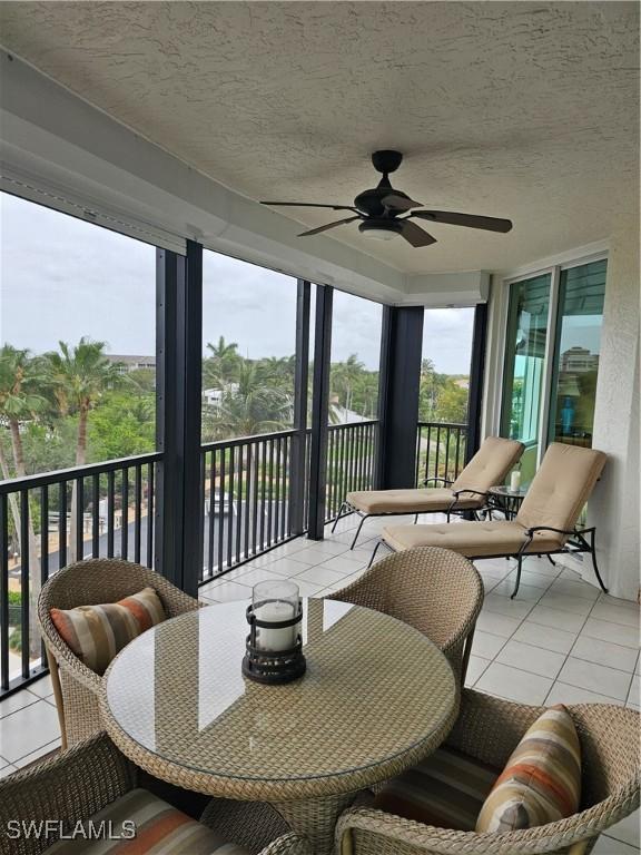 430 Cove Tower Dr Unit 501, Naples, FL 34110 - sunroom / solarium featuring tile patterned flooring, a ceiling fan, and a textured ceiling
