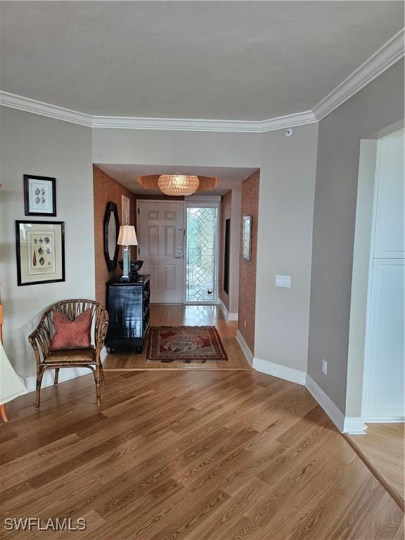 430 Cove Tower Dr Unit 501, Naples, FL 34110 - entryway with light wood-style floors, crown molding, and baseboards