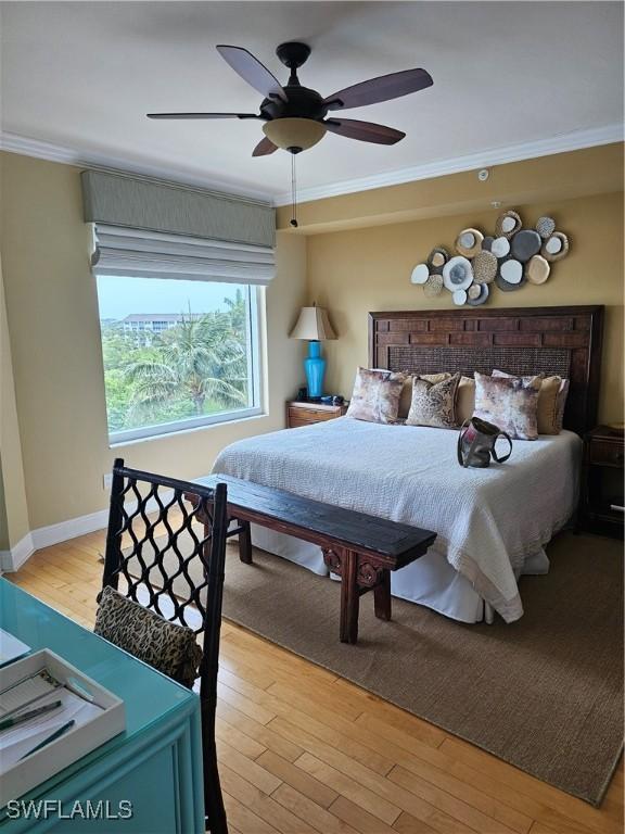 430 Cove Tower Dr Unit 501, Naples, FL 34110 - bedroom featuring ornamental molding, hardwood / wood-style floors, baseboards, and ceiling fan