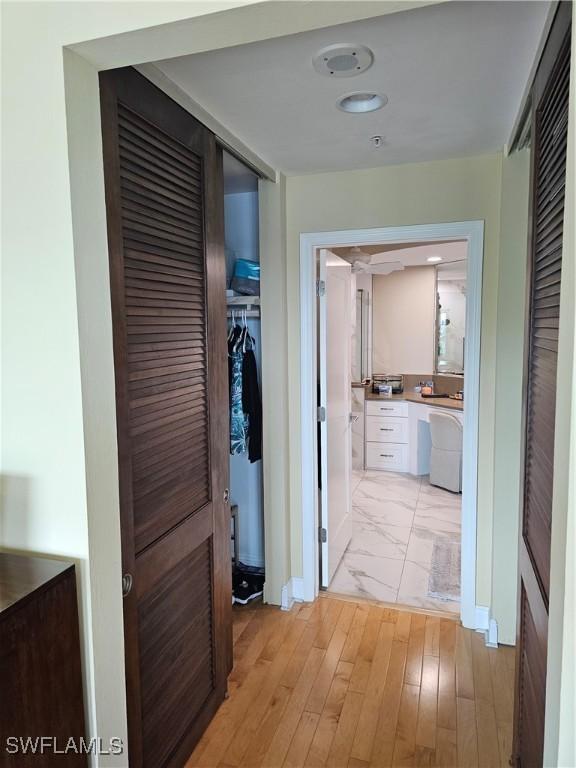 430 Cove Tower Dr Unit 501, Naples, FL 34110 - hallway featuring light marble finish flooring