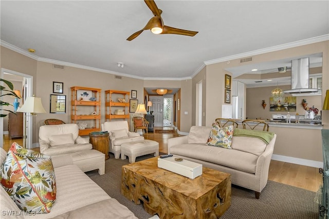 430 Cove Tower Dr Unit 501, Naples, FL 34110 - living room with ceiling fan, wood finished floors, and ornamental molding