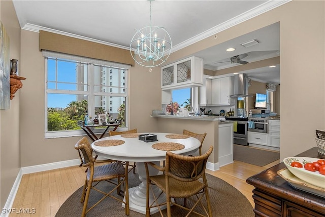 430 Cove Tower Dr Unit 501, Naples, FL 34110 - dining space featuring ornamental molding, light wood-type flooring, and a chandelier