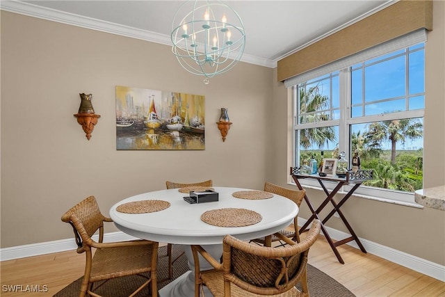 430 Cove Tower Dr Unit 501, Naples, FL 34110 - dining space with a chandelier, light wood finished floors, and crown molding