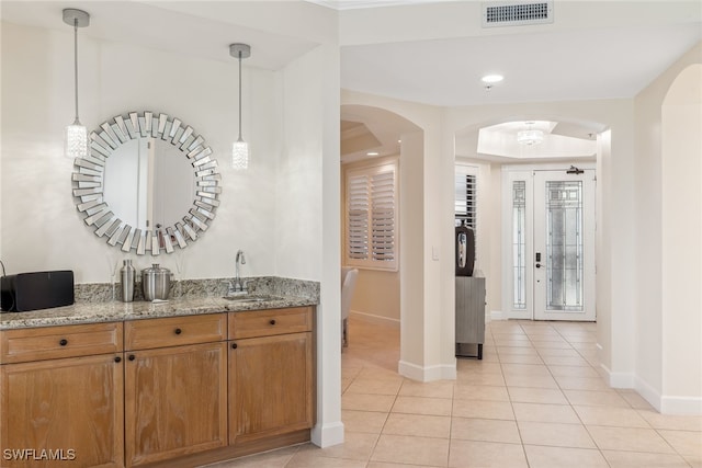 11600 Court Of Palms Unit 201, Fort Myers, FL 33908 - indoor wet bar featuring baseboards, light tile patterned flooring, arched walkways, decorative light fixtures, and recessed lighting