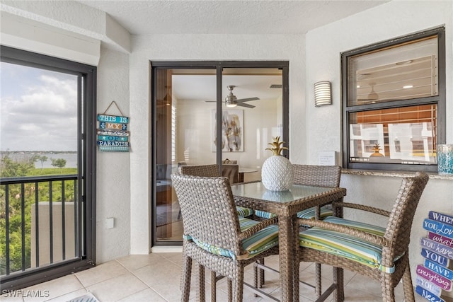11600 Court Of Palms Unit 201, Fort Myers, FL 33908 - tiled dining space with a textured wall, ceiling fan, and a textured ceiling