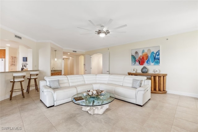 11600 Court Of Palms Unit 201, Fort Myers, FL 33908 - living room with arched walkways, a ceiling fan, ornamental molding, light tile patterned flooring, and baseboards
