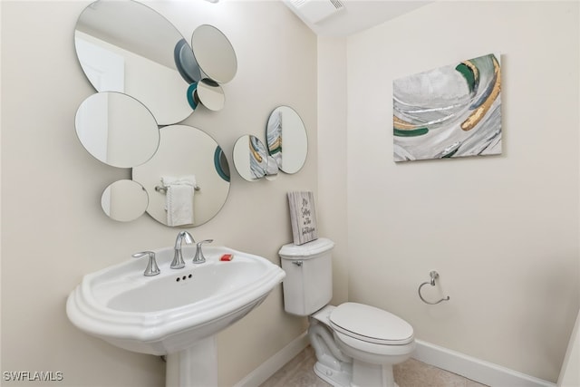 11600 Court Of Palms Unit 201, Fort Myers, FL 33908 - bathroom with baseboards, toilet, and a sink