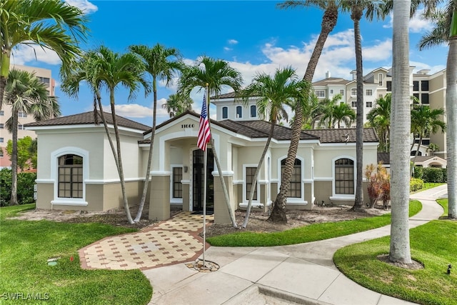 11600 Court Of Palms Unit 201, Fort Myers, FL 33908 - mediterranean / spanish house featuring stucco siding and a front yard
