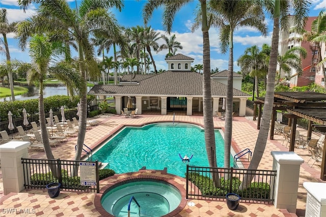 11600 Court Of Palms Unit 201, Fort Myers, FL 33908 - view of pool with a patio area, a water view, and a pool with connected hot tub