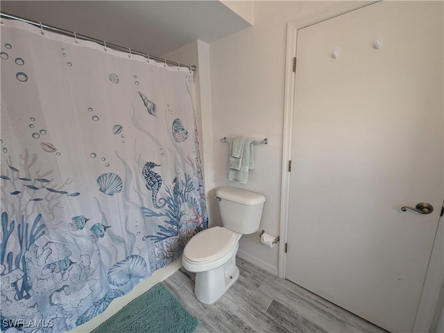 11250 Porpoise Point Rd Unit 8, Matlacha, FL 33993 - full bath featuring toilet, wood finished floors, baseboards, and curtained shower
