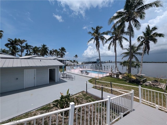 11250 Porpoise Point Rd Unit 8, Matlacha, FL 33993 - wooden deck featuring a community pool, a patio, and a water view