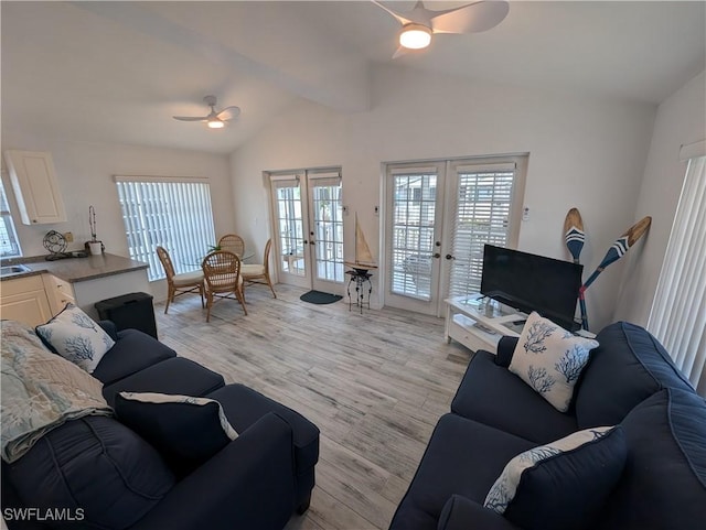 11250 Porpoise Point Rd Unit 8, Matlacha, FL 33993 - living room featuring a ceiling fan, french doors, vaulted ceiling, and light wood-style flooring