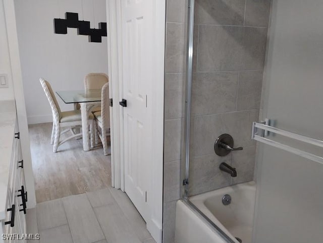 5116 Coronado Pkwy Unit 16, Cape Coral, FL 33904 - full bathroom with washtub / shower combination, wood finished floors, and vanity