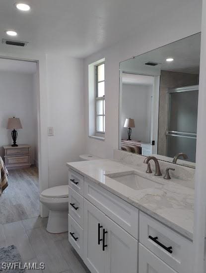 5116 Coronado Pkwy Unit 16, Cape Coral, FL 33904 - full bath featuring vanity, connected bathroom, toilet, an enclosed shower, and recessed lighting