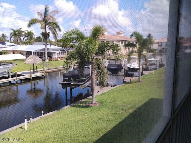 5116 Coronado Pkwy Unit 16, Cape Coral, FL 33904 - dock area featuring a water view, boat lift, and a yard