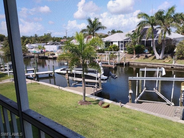 5116 Coronado Pkwy Unit 16, Cape Coral, FL 33904 - dock area featuring boat lift, a water view, a lawn, and a residential view