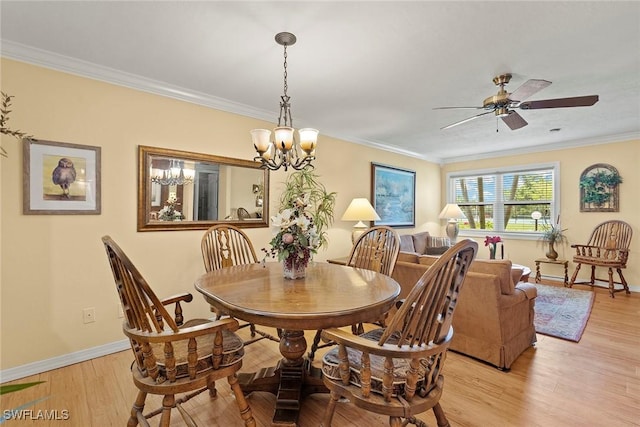 8411 Charter Club Cir Unit 1, Fort Myers, FL 33919 - dining room featuring crown molding, light wood finished floors, ceiling fan, baseboards, and a chandelier