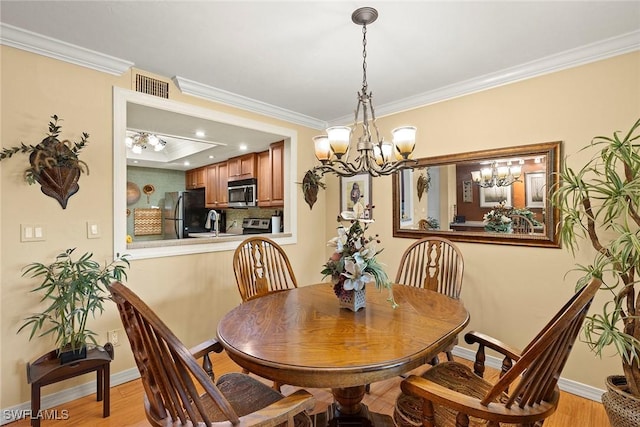 8411 Charter Club Cir Unit 1, Fort Myers, FL 33919 - dining room with ornamental molding, light wood-type flooring, a chandelier, and baseboards