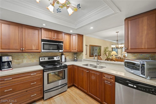 8411 Charter Club Cir Unit 1, Fort Myers, FL 33919 - kitchen with appliances with stainless steel finishes, a sink, a chandelier, crown molding, and brown cabinets