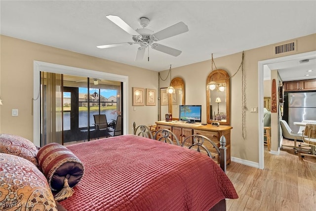 8411 Charter Club Cir Unit 1, Fort Myers, FL 33919 - bedroom with access to outside, freestanding refrigerator, light wood-style floors, baseboards, and ceiling fan