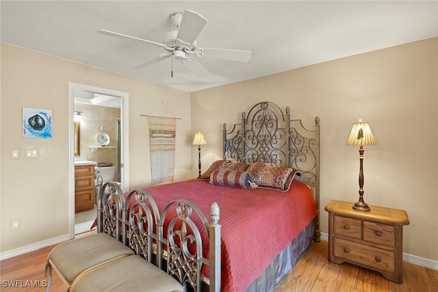 8411 Charter Club Cir Unit 1, Fort Myers, FL 33919 - bedroom featuring baseboards, light wood-style floors, ensuite bath, and a ceiling fan