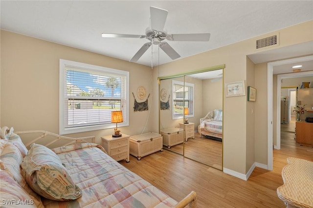8411 Charter Club Cir Unit 1, Fort Myers, FL 33919 - bedroom featuring a closet, light wood-type flooring, baseboards, and a ceiling fan