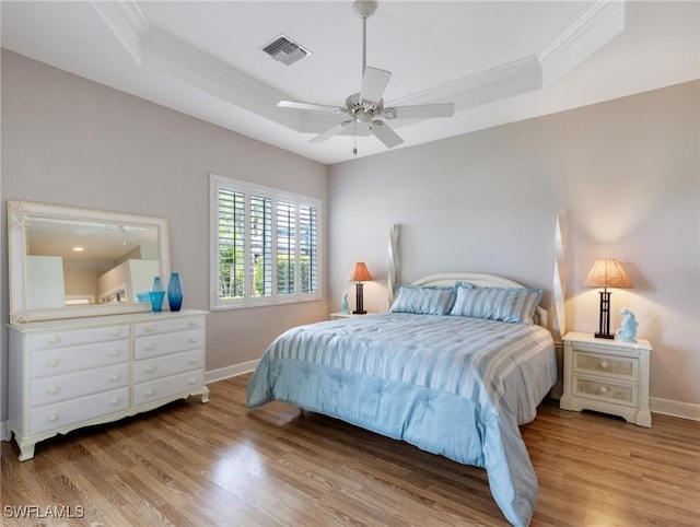 10230 Cobble Hill Rd, Bonita Springs, FL 34135 - bedroom with crown molding, a tray ceiling, baseboards, and wood finished floors